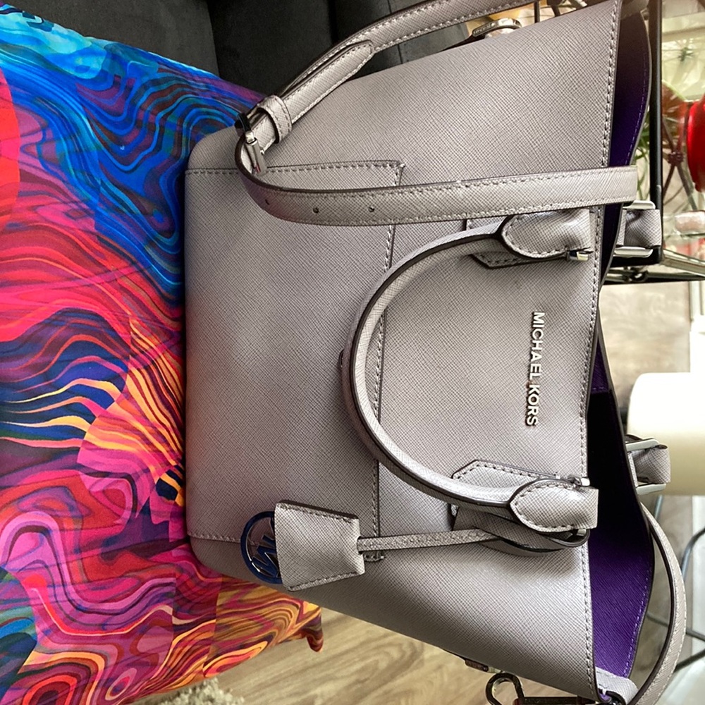 Grey Michael Kors handbag with snap closure.